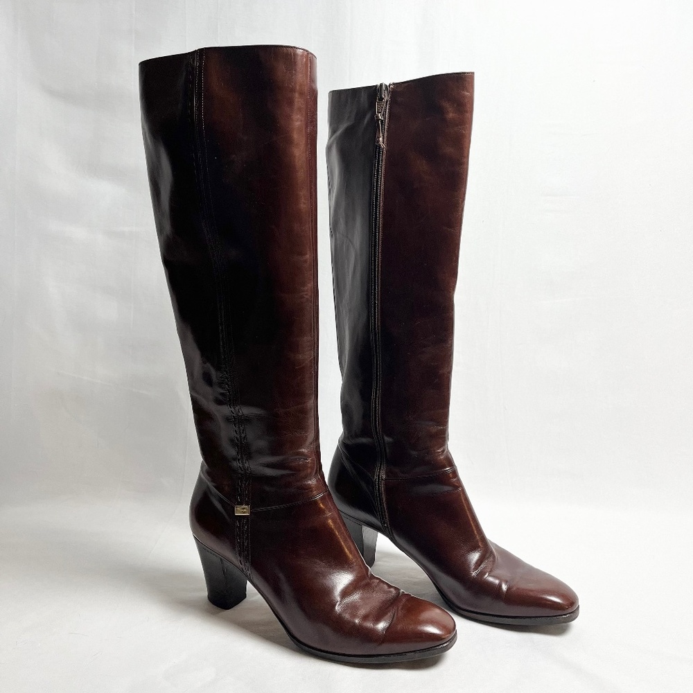 Brown leather knee high heeled boots